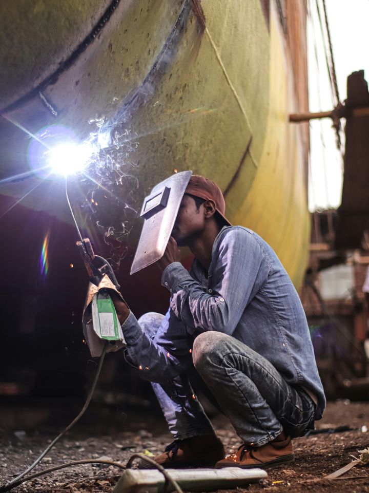 Welder at work on a ship’s hull